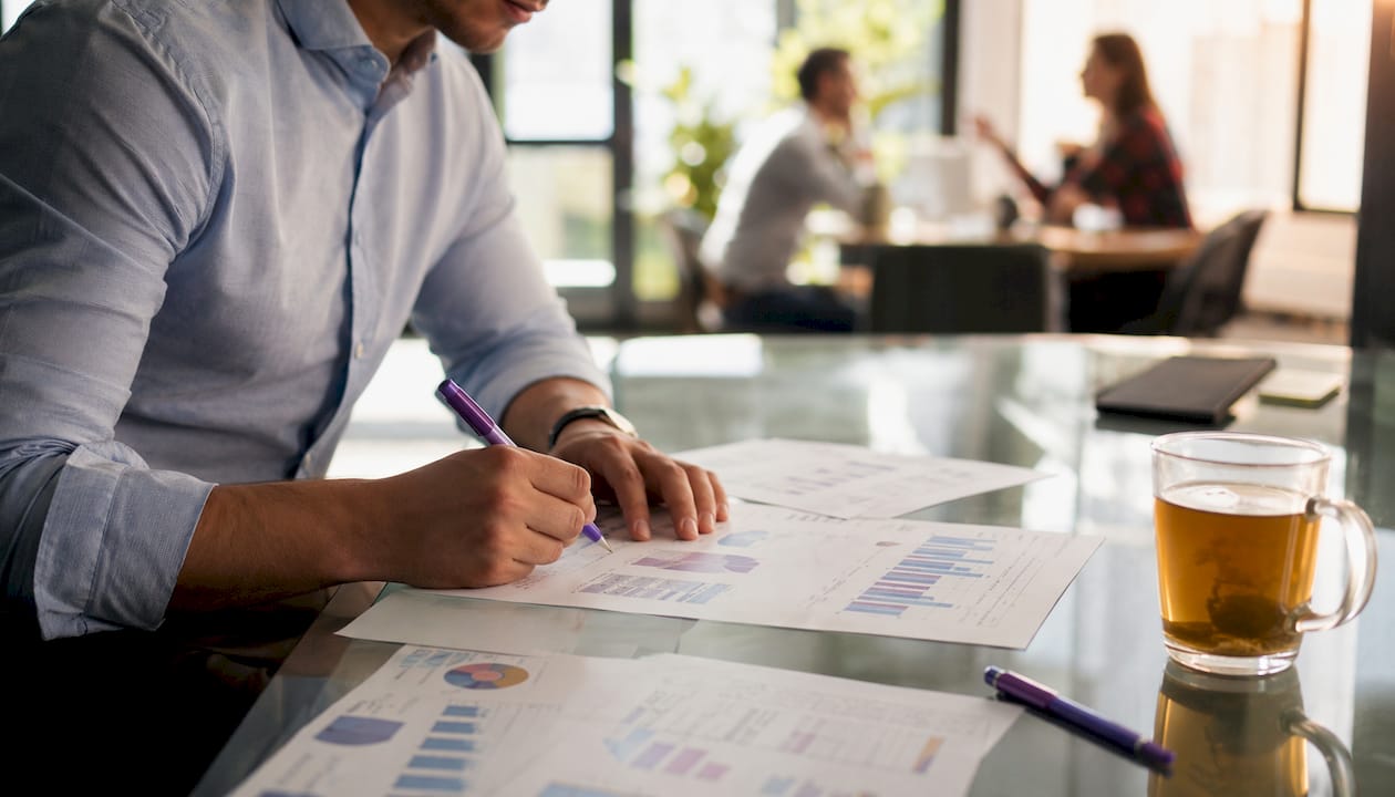 Sales rep analyzing sales metrics documents