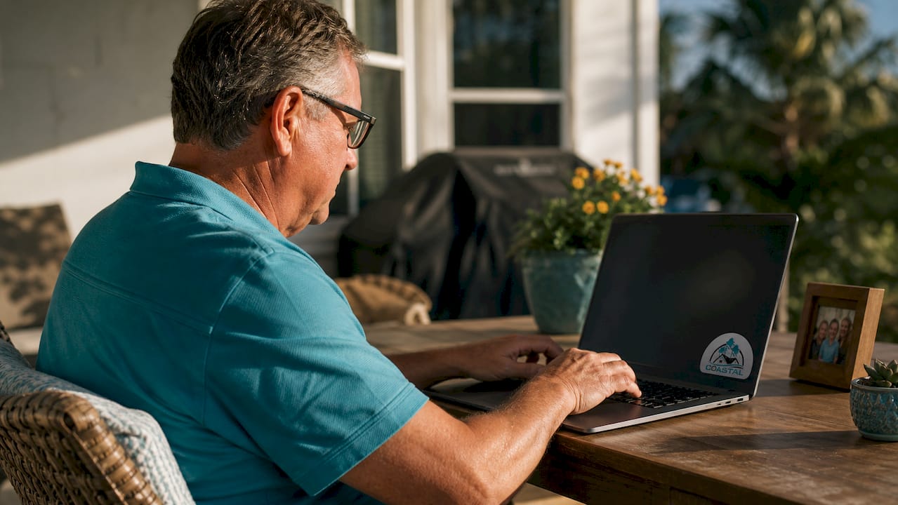 Hands typing warranty claim on laptop