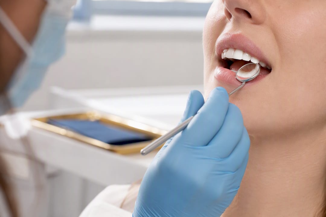 Dentist examining a patient’s sensitive gumline
