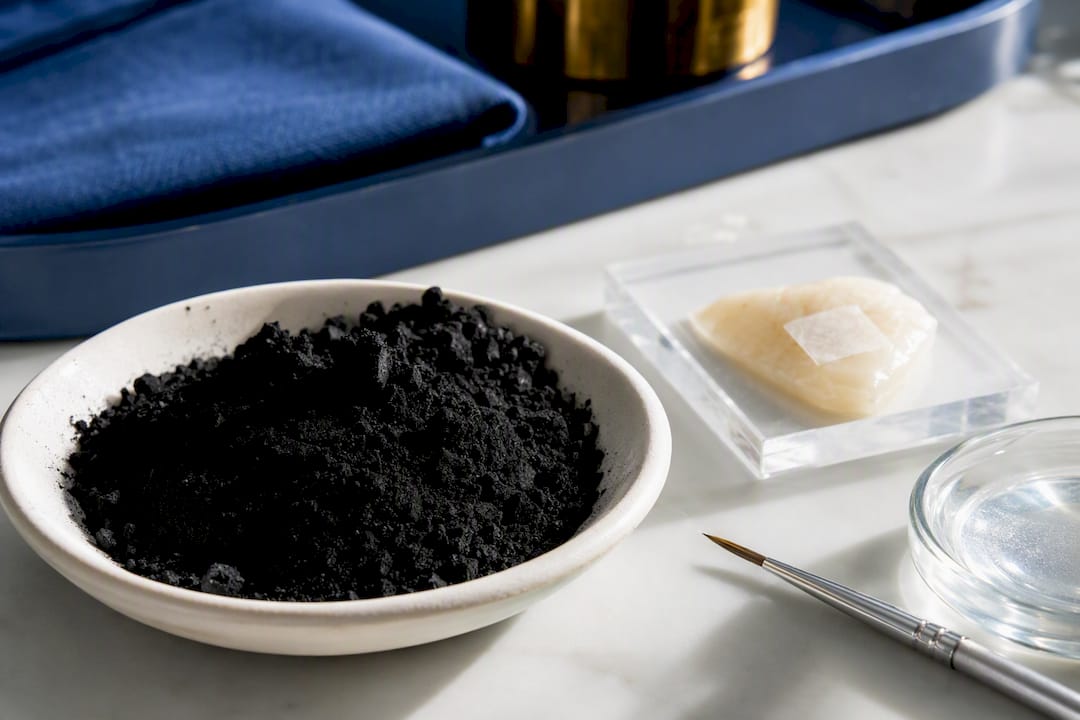 Charcoal powder beside enamel test sample