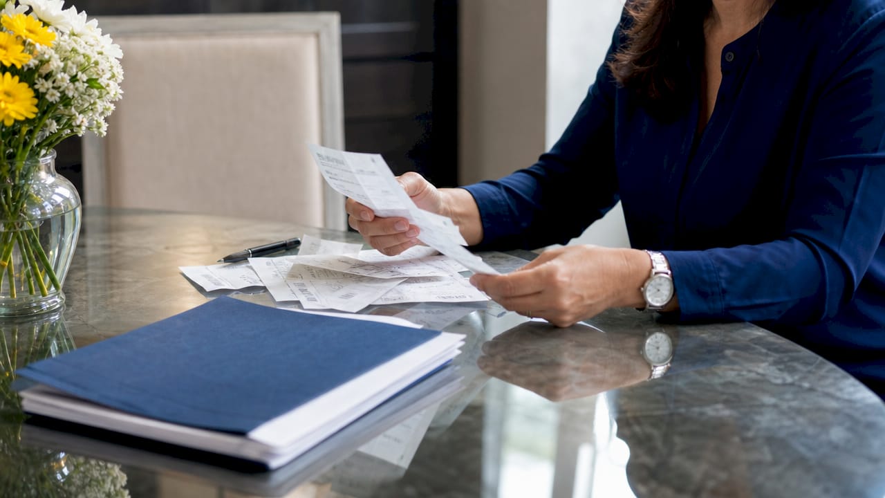 Hands sorting truck accident expense receipts