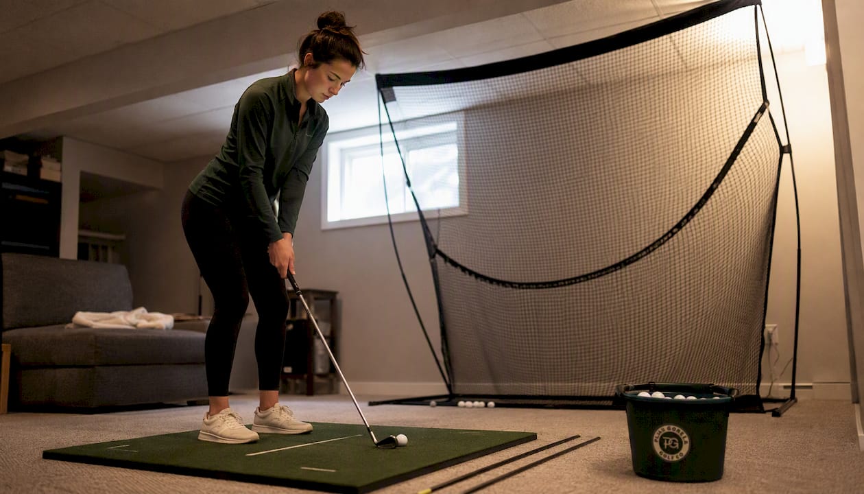 Woman practicing short-game wedge in backyard