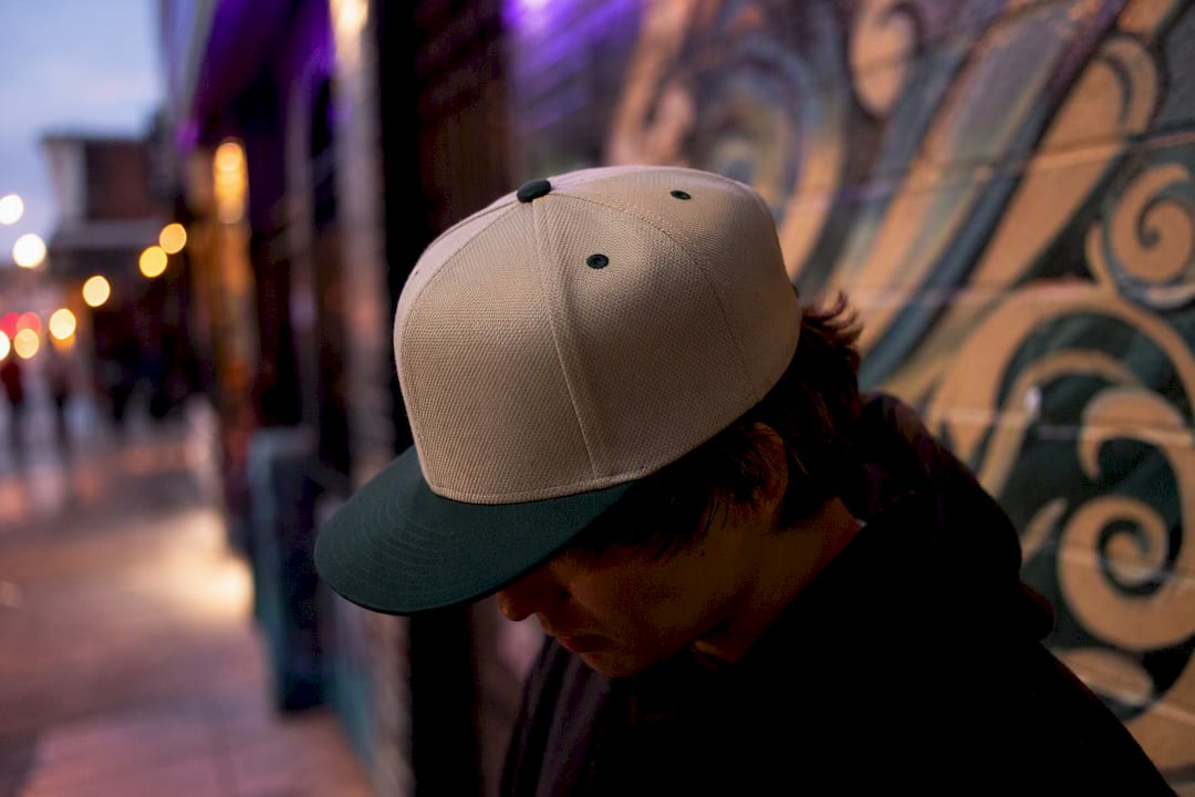 Flat-brim snapback on urban streetwear scene