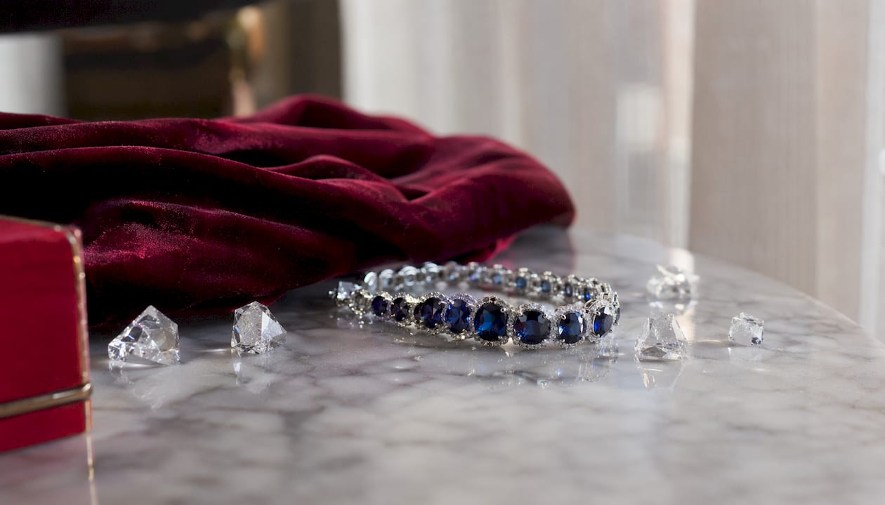 Close-up sapphire stud earrings on wooden table