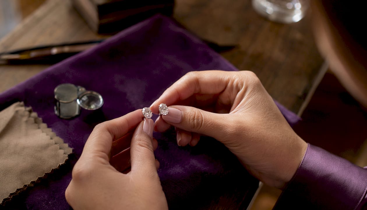 Close-up of diamond stud earrings on table