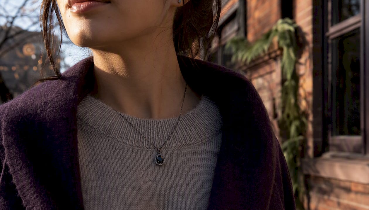 Dark gemstone necklace on winter streetwear
