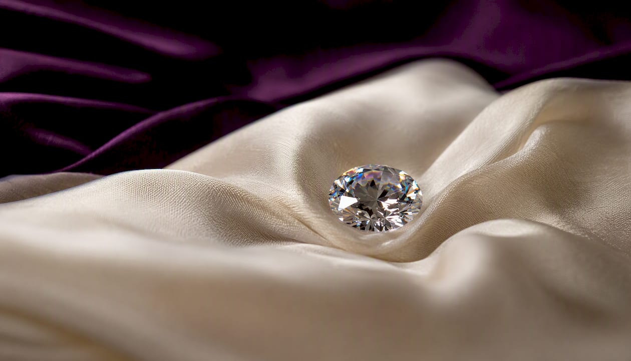 Sparkling lab-grown moissanite gemstone on purple velvet