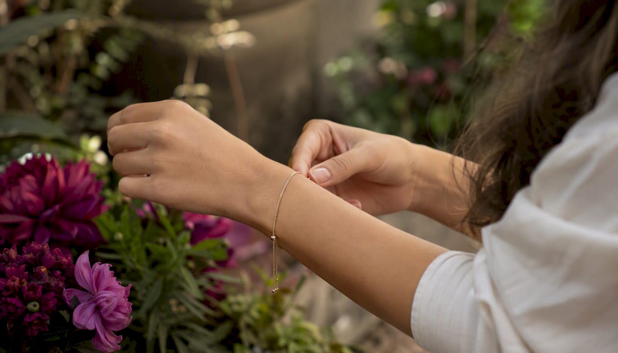 Hand adjusting bracelet extender on wrist