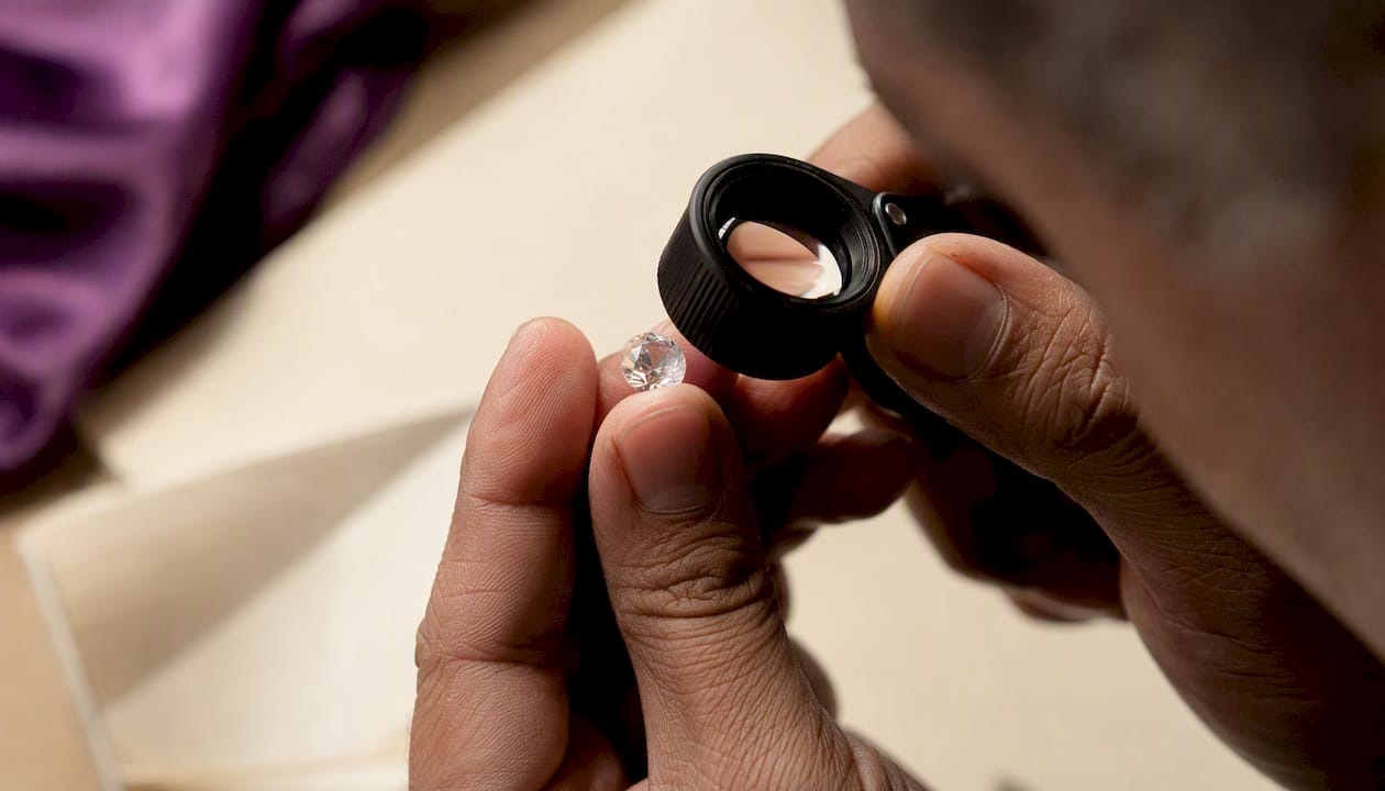 Jeweler inspecting diamond cut quality