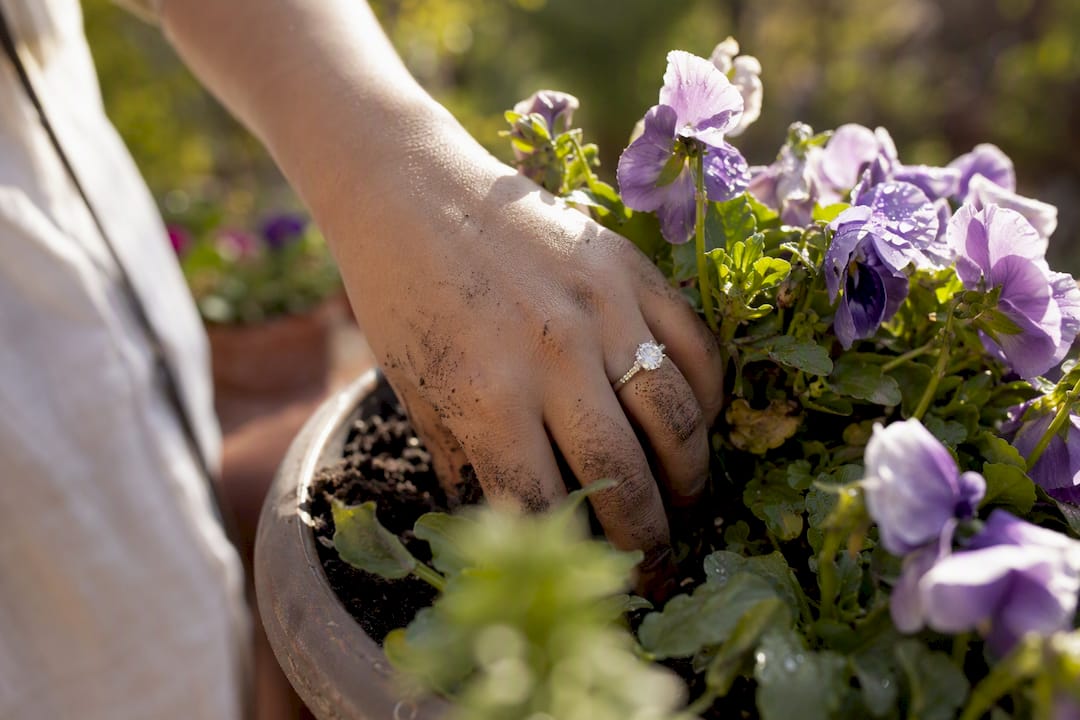 Hand wearing moissanite ring during dishwashing