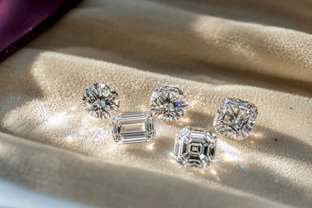Loose moissanite gems in various cuts showing sparkle differences