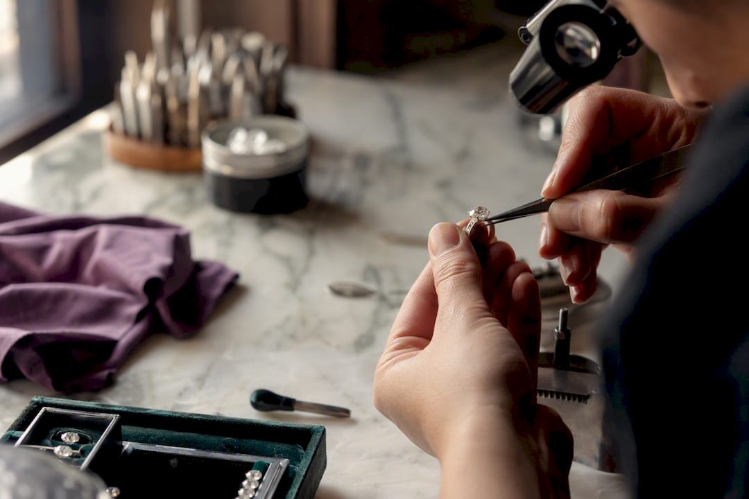 Jeweler setting lab-grown gemstone on ring
