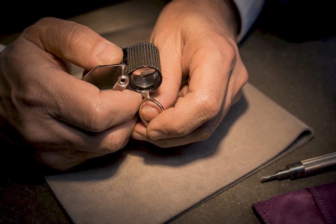Jeweler inspecting cropped ring prongs