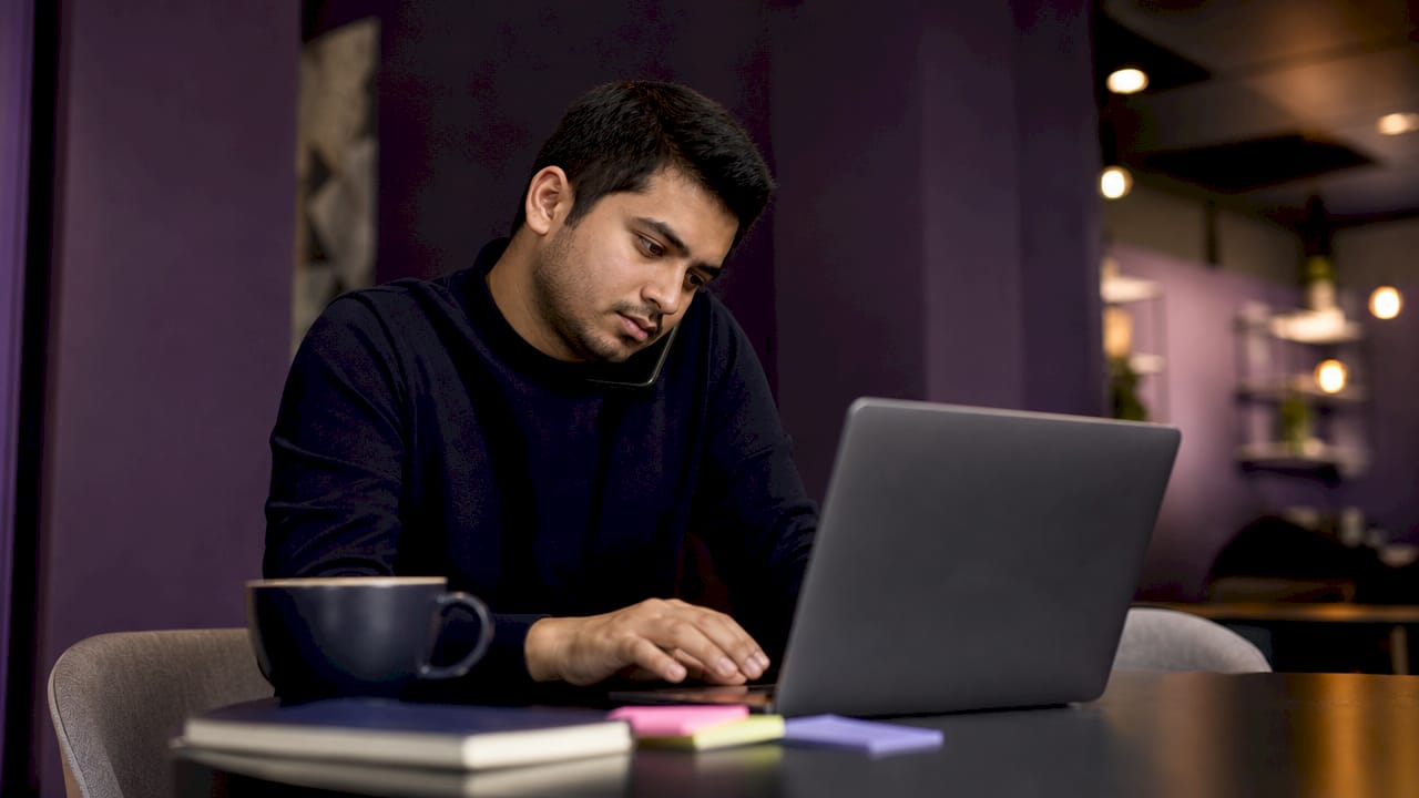 Man at coworking space setting up marketing campaign links