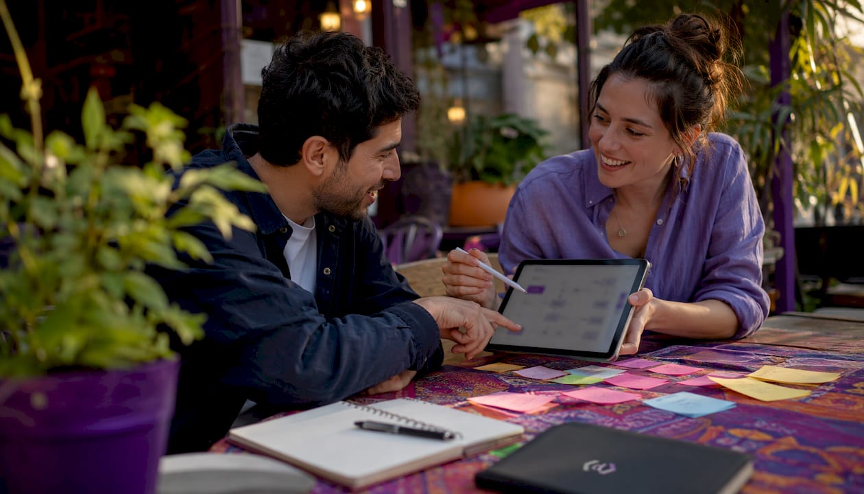 Hands collaborating using tablet in modern workspace
