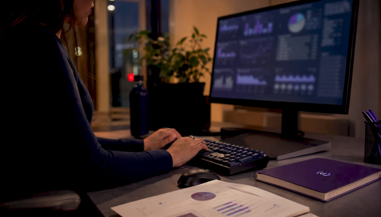 Hands typing in data analyst workspace
