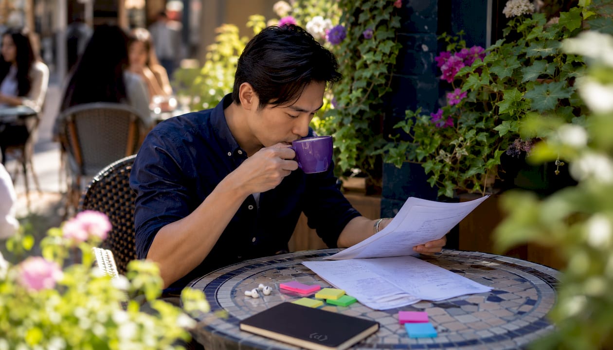 Marketer planning video repurposing in café setting