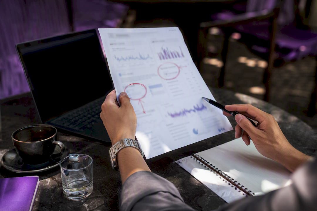 Hands reviewing marketing data charts