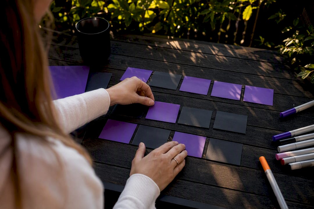Hands arranging social media content tiles