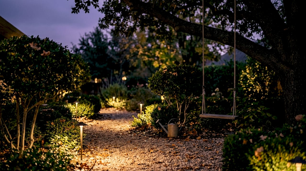 Outdoor Lighting Scene Setting: A Homeowner's Guide Evening garden pathway lit by warm outdoor lights