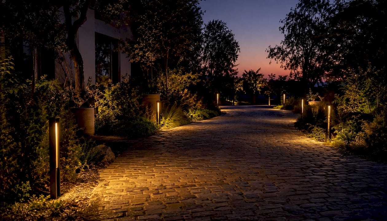 Driveway Lighting Ideas and Benefits: 2026 Guide Bollard lights lining driveway edge