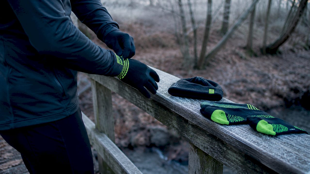 Cold weather running gloves, beanie, and shoes close-up
