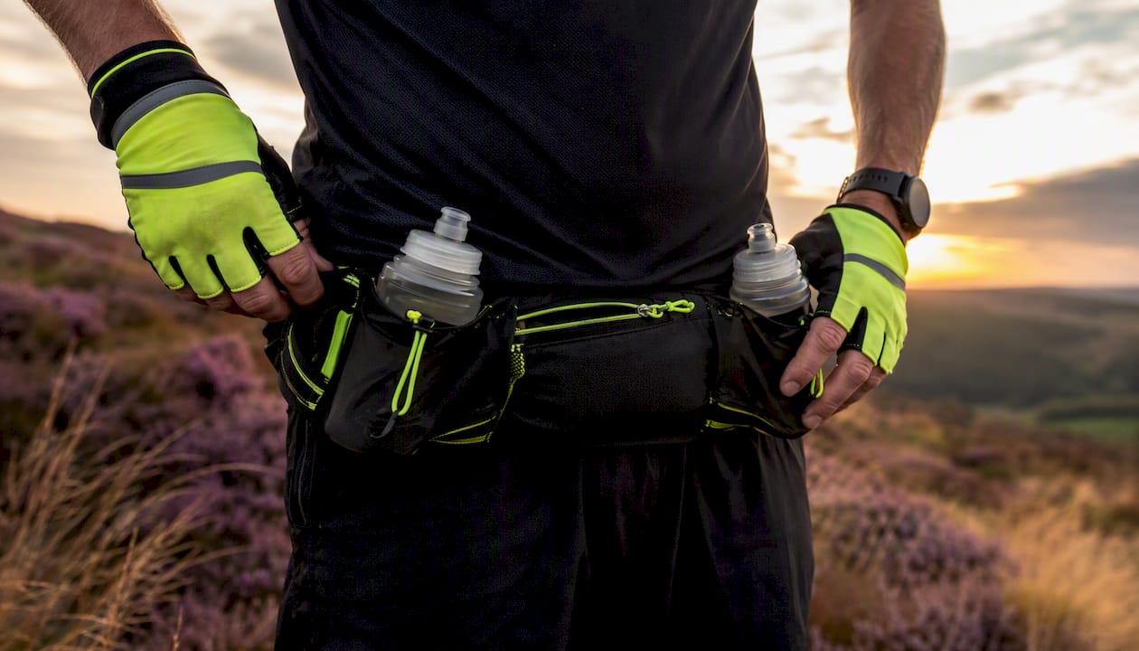Close-up hands gripping hydration running belt