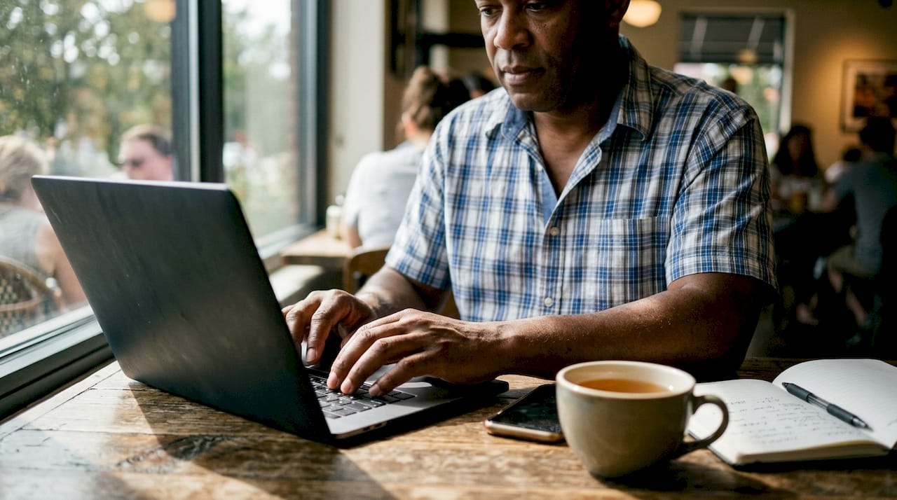 Man working with social media tools at co-working table