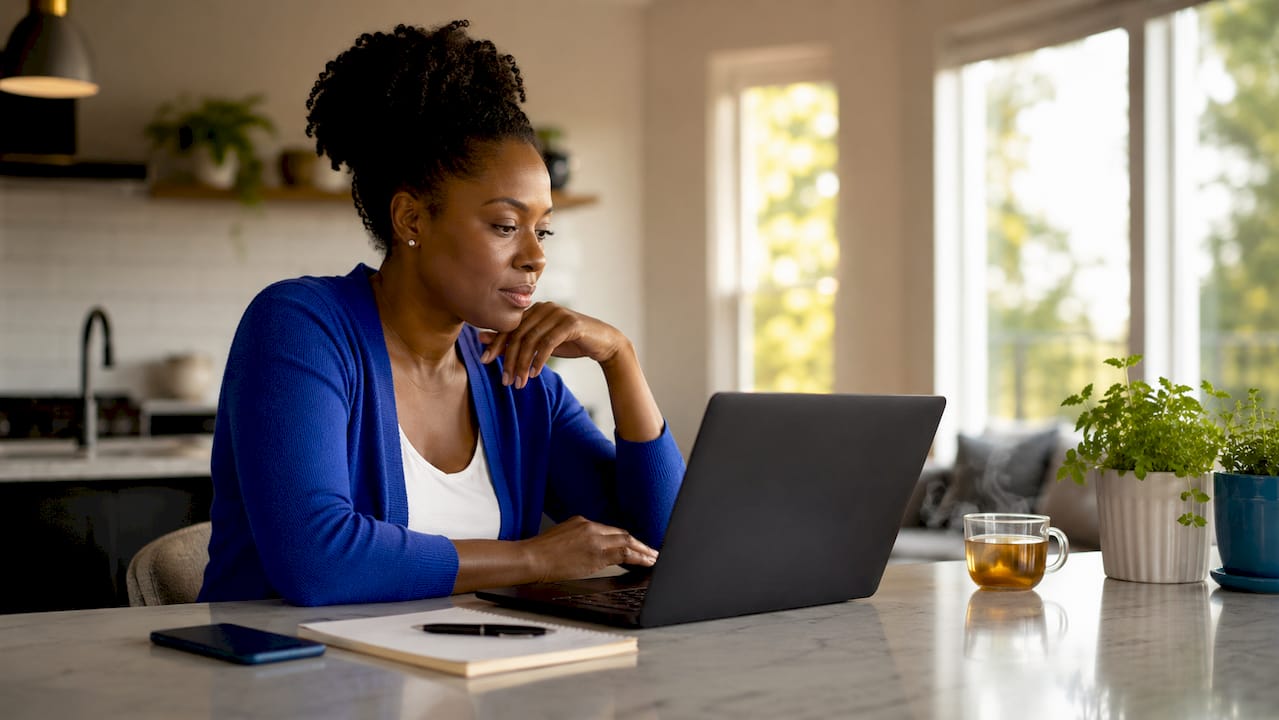 Woman reviewing remote job listings on laptop