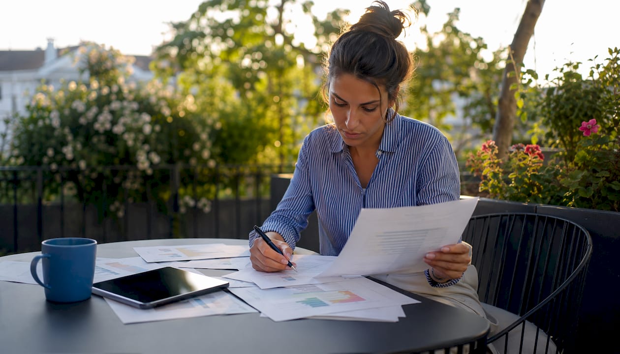 Tutor analyzing income documents at desk