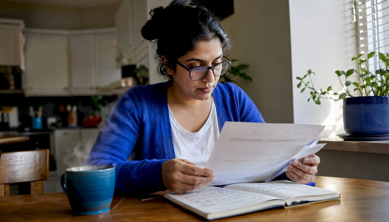Woman reviewing remote job listings at home