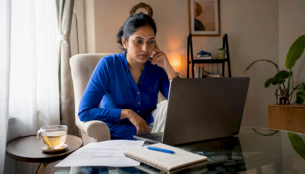 Woman reviewing remote job listings at home