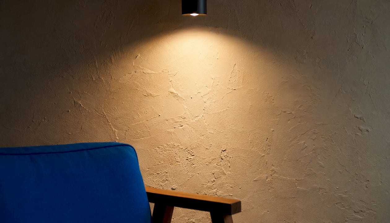Textured plaster wall with directional lighting shadows