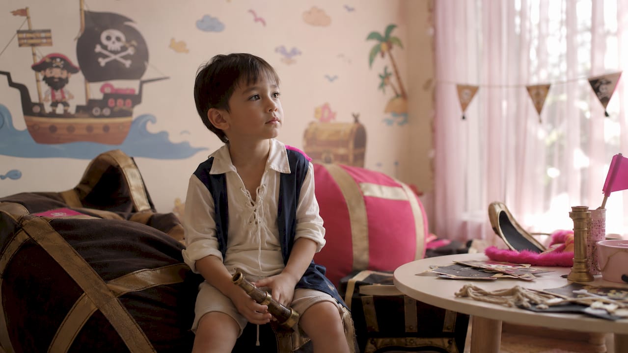 Shy child comfort at themed party corner