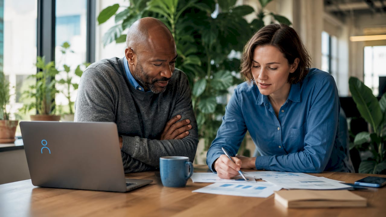 Two colleagues reviewing payroll reports together