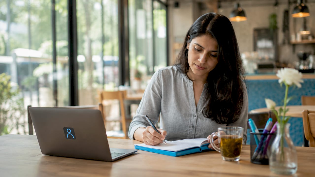 Employee writing notes on corporate values