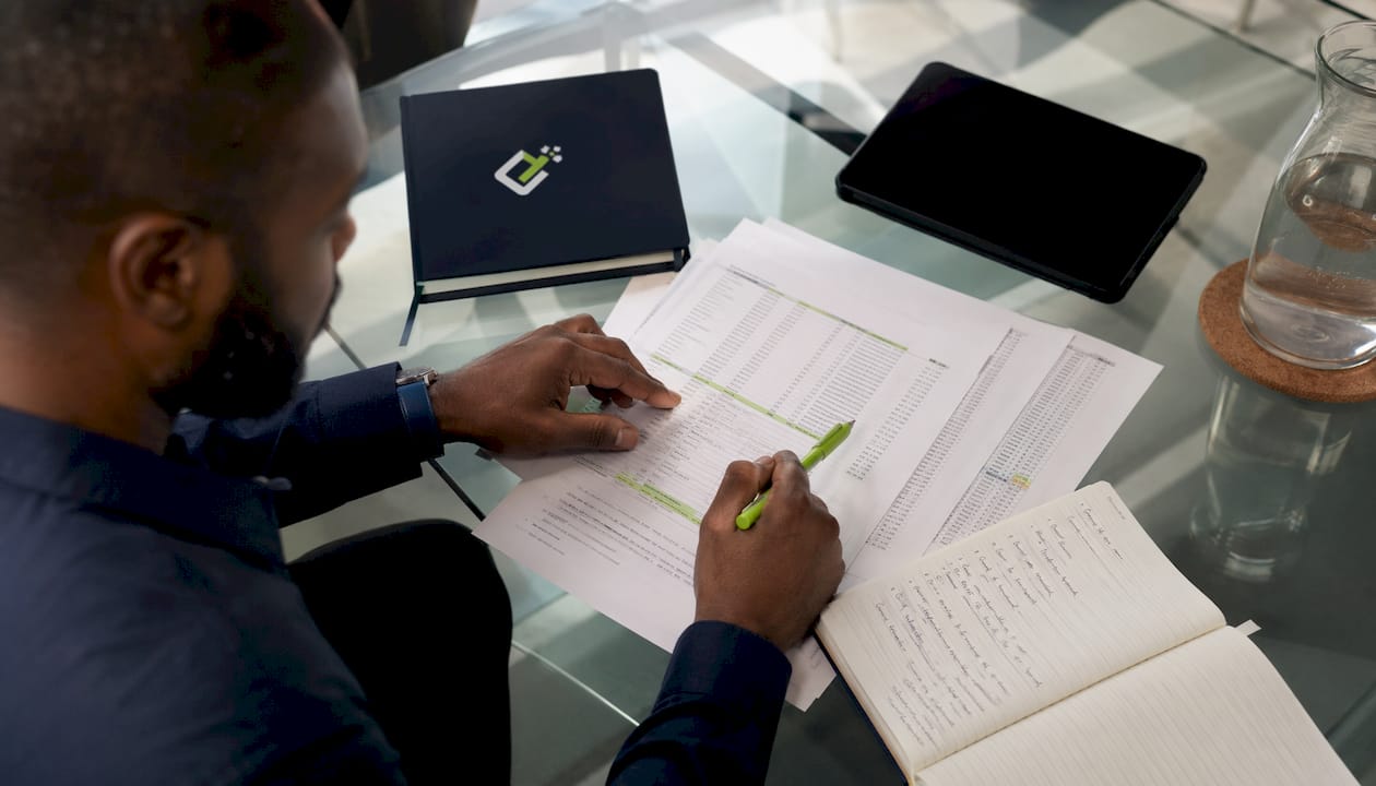 Hands highlighting payroll register and worksheets