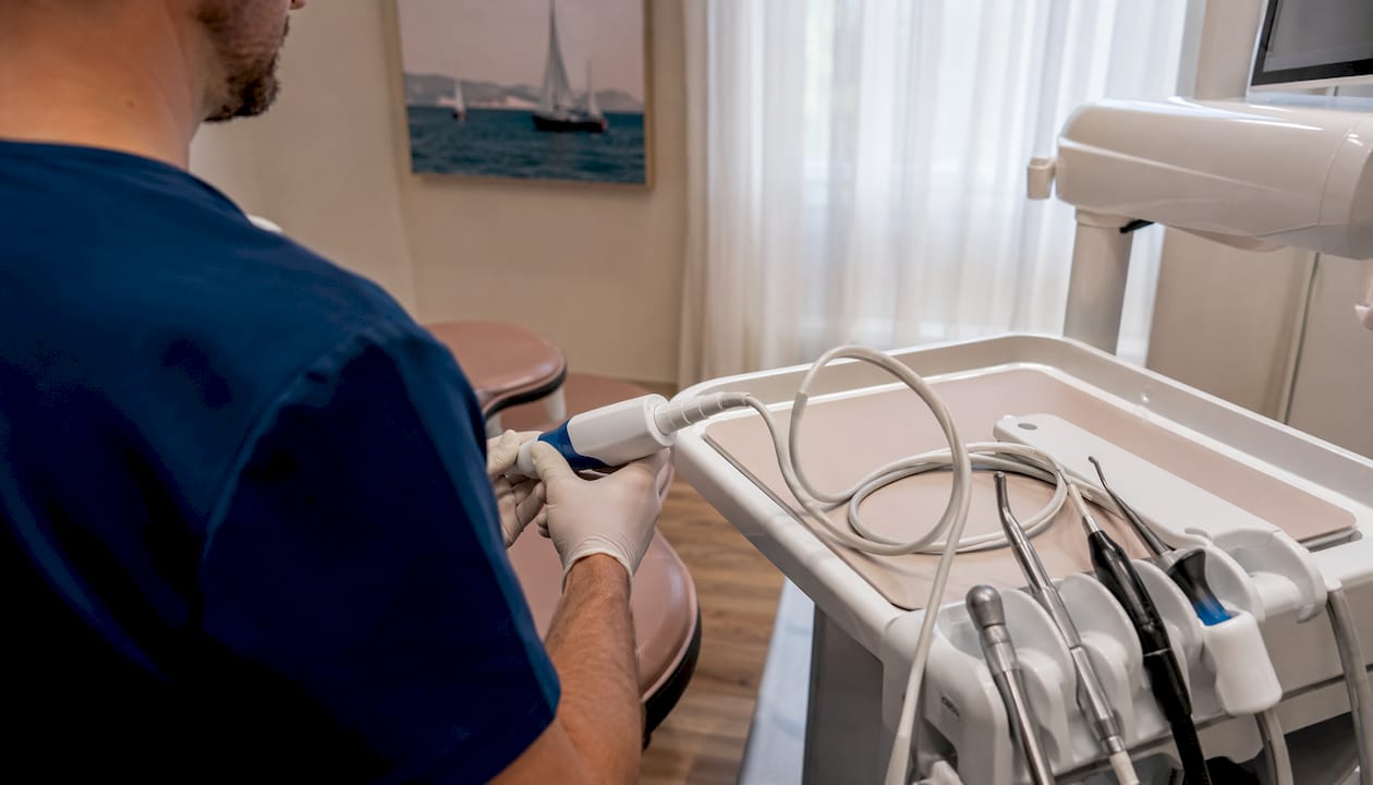 Dentist using digital intraoral scanner hands close-up
