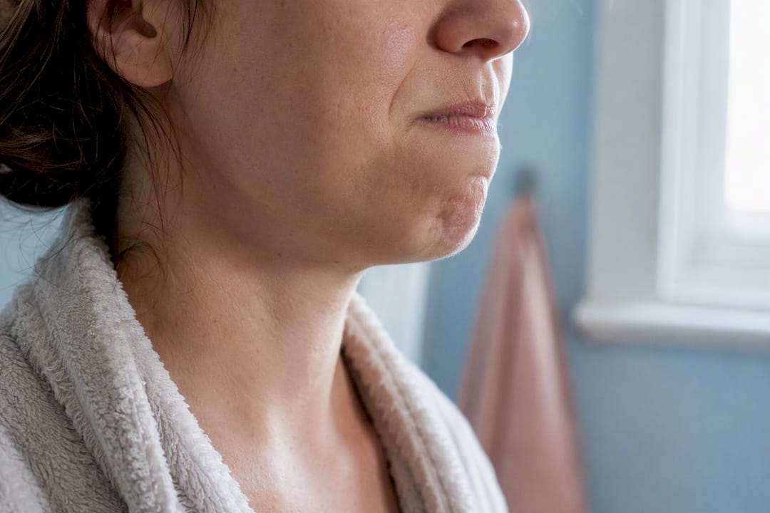 Close-up jaw muscle clenching tension