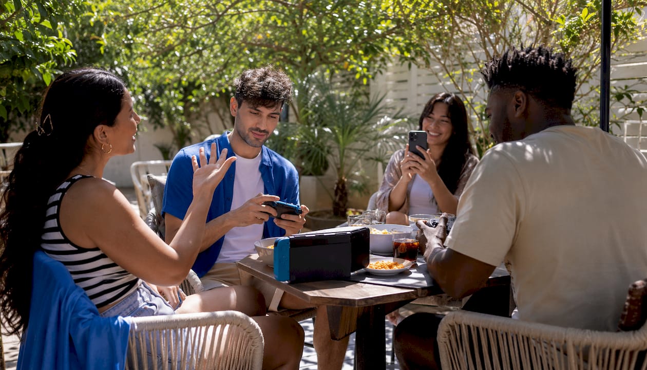 Diverse group preparing for mixed-platform game night