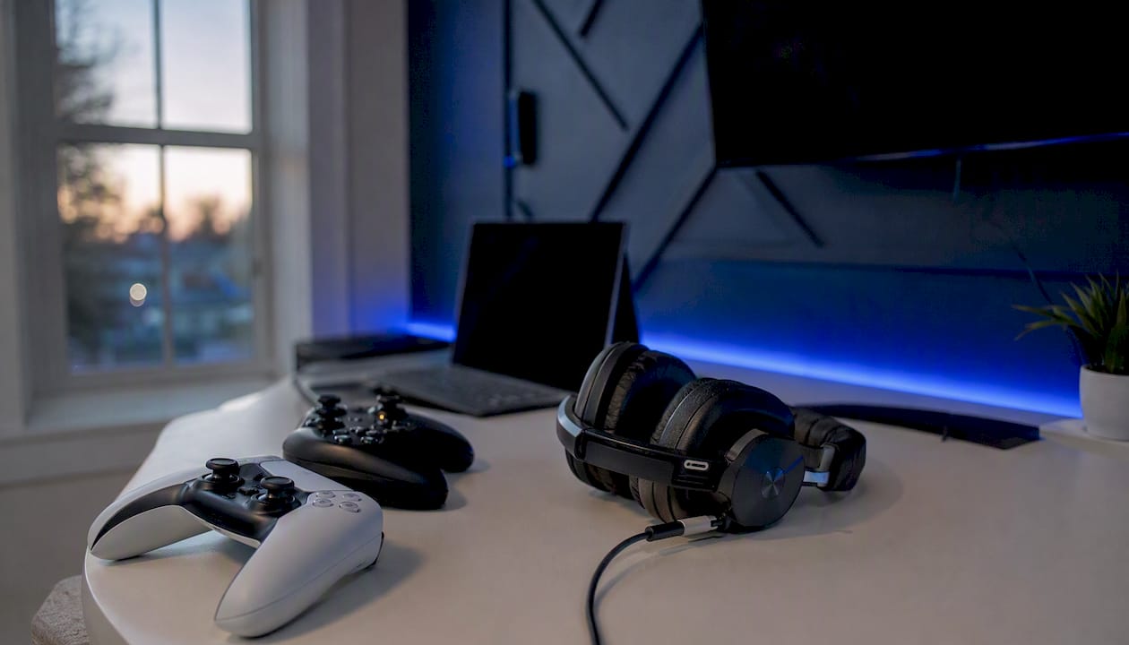 Gaming controllers and headset in blue-lit room
