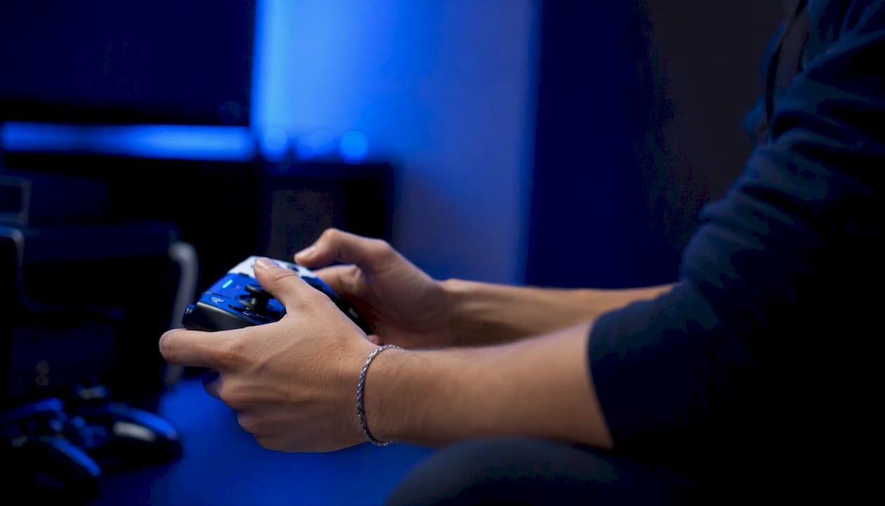 Hands holding controller during competitive game