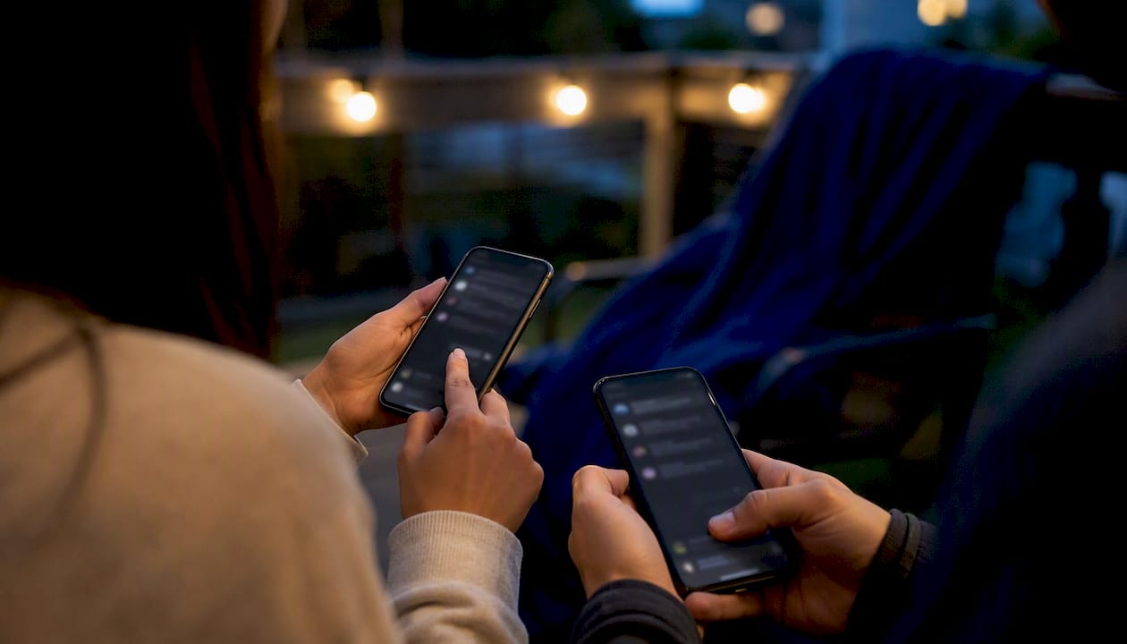 Hands sharing interactive voting link on smartphones