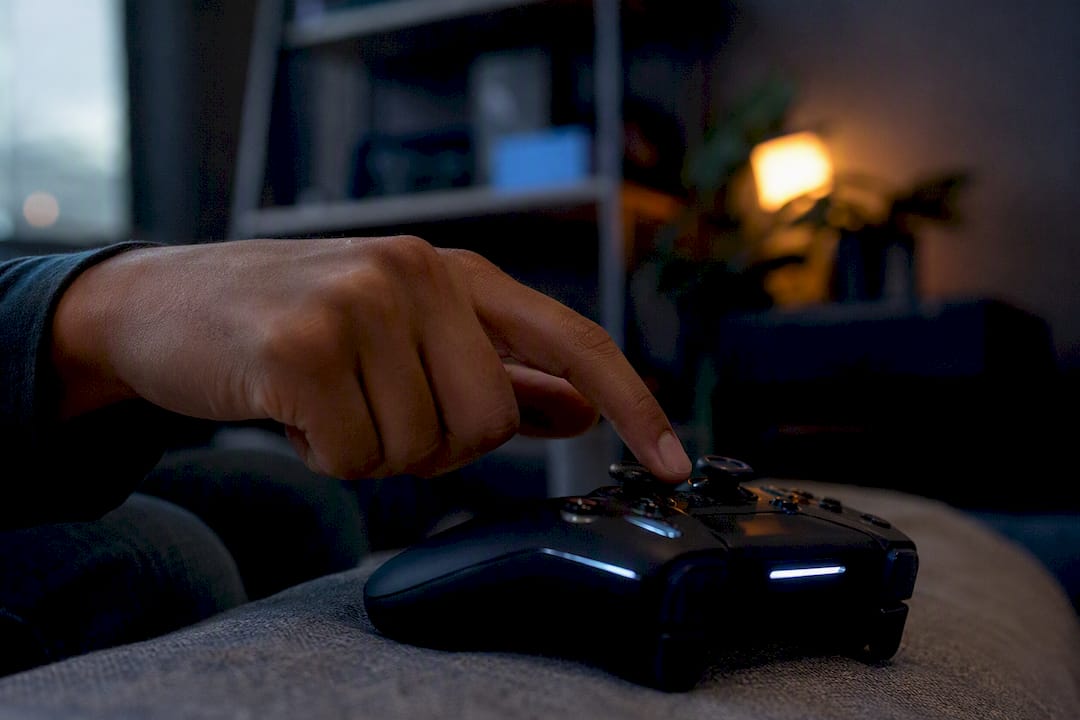 Hand pressing button on game controller