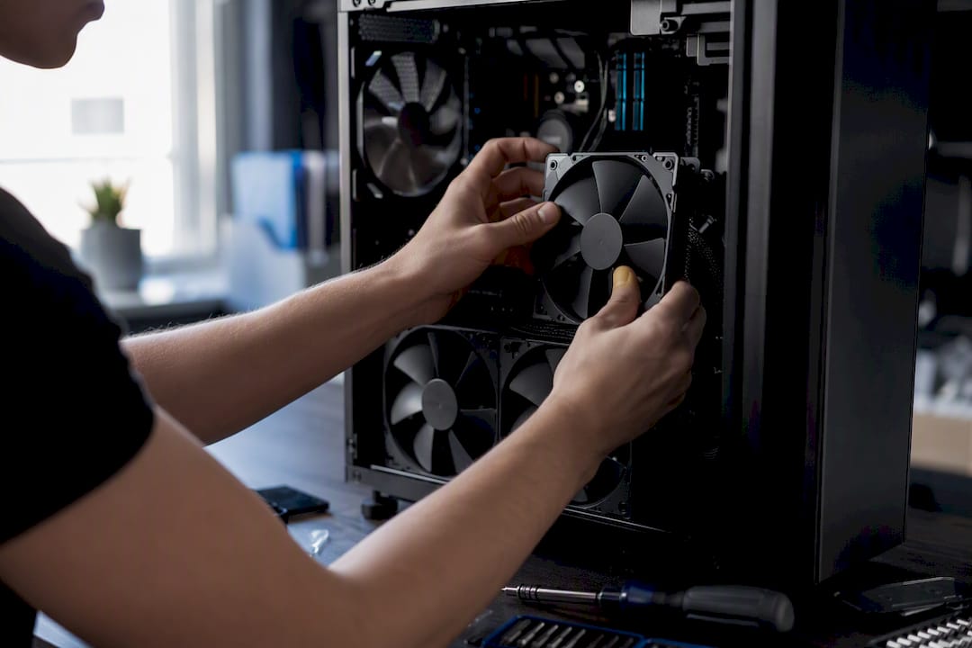 Hands installing RAM in gaming PC
