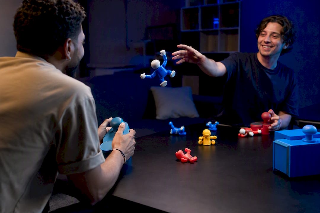 Hands interacting with physics-based party game pieces