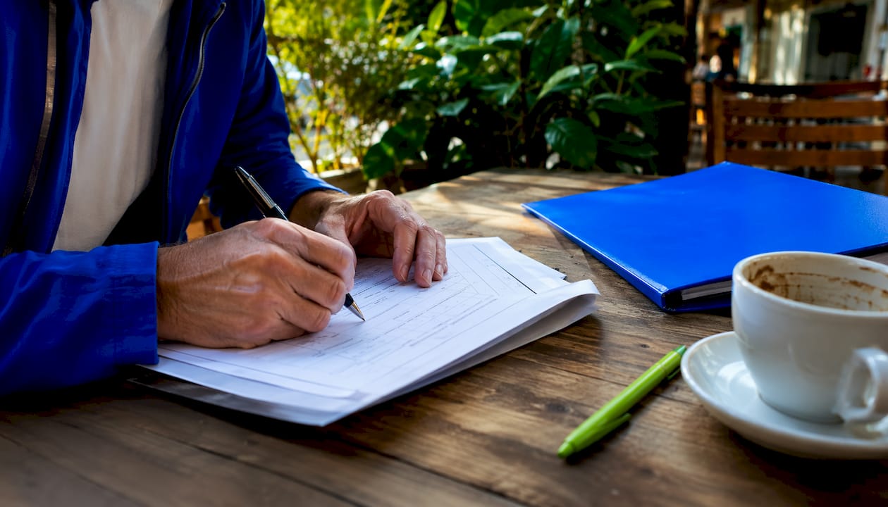 Overhead of hands completing duplicate title form