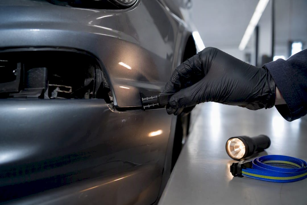 Adjuster inspecting damaged bumper seam