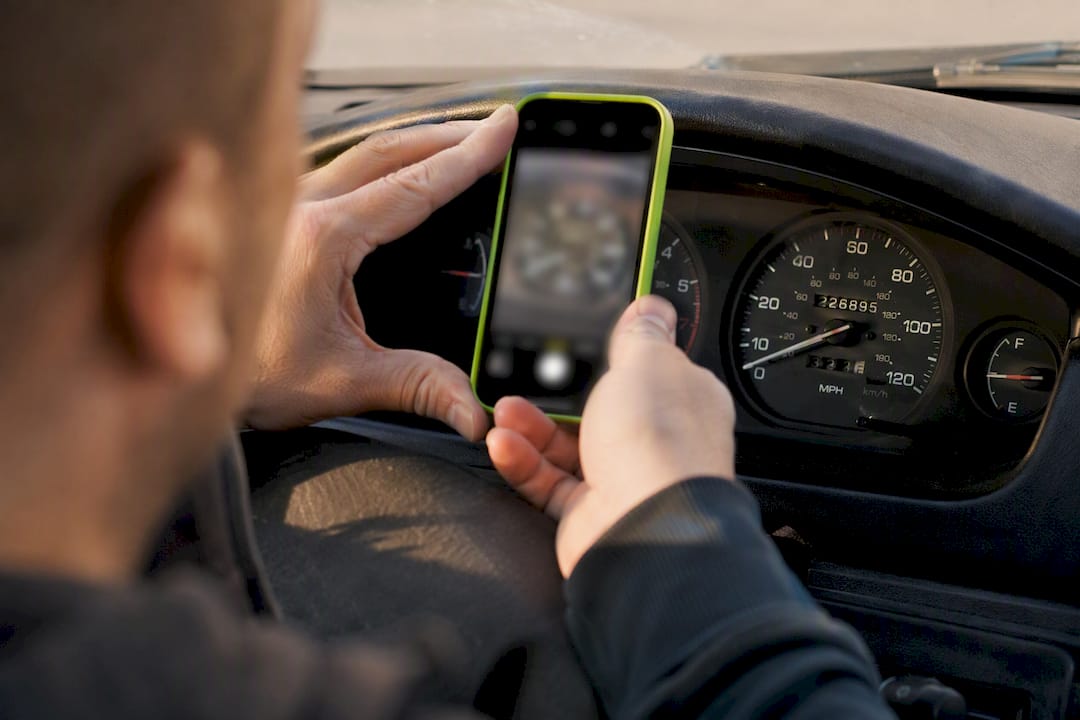 Seller photographing a vehicle odometer