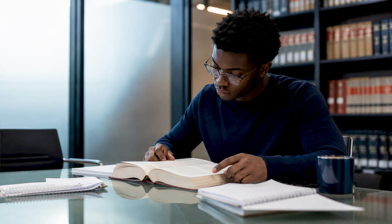 Law student studying proximate cause in library